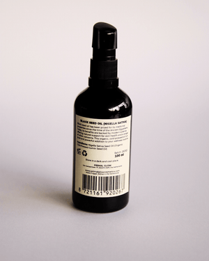 Primal Glow biologische en koudgeperste zwarte komijnolie in een donkere glazen fles.